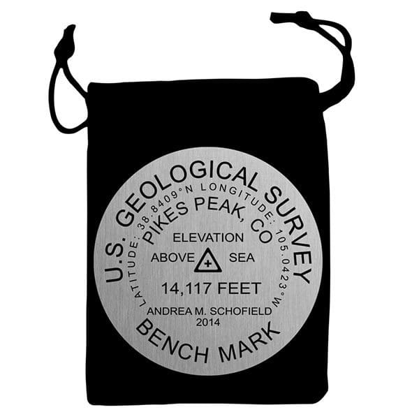 A black bag with a silver seal on it.