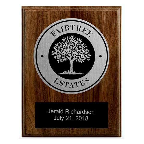 A plaque with the name of a person and tree on it.