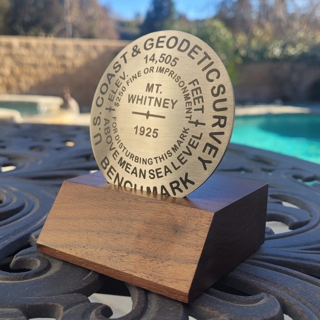A wooden plaque sitting on top of a table.