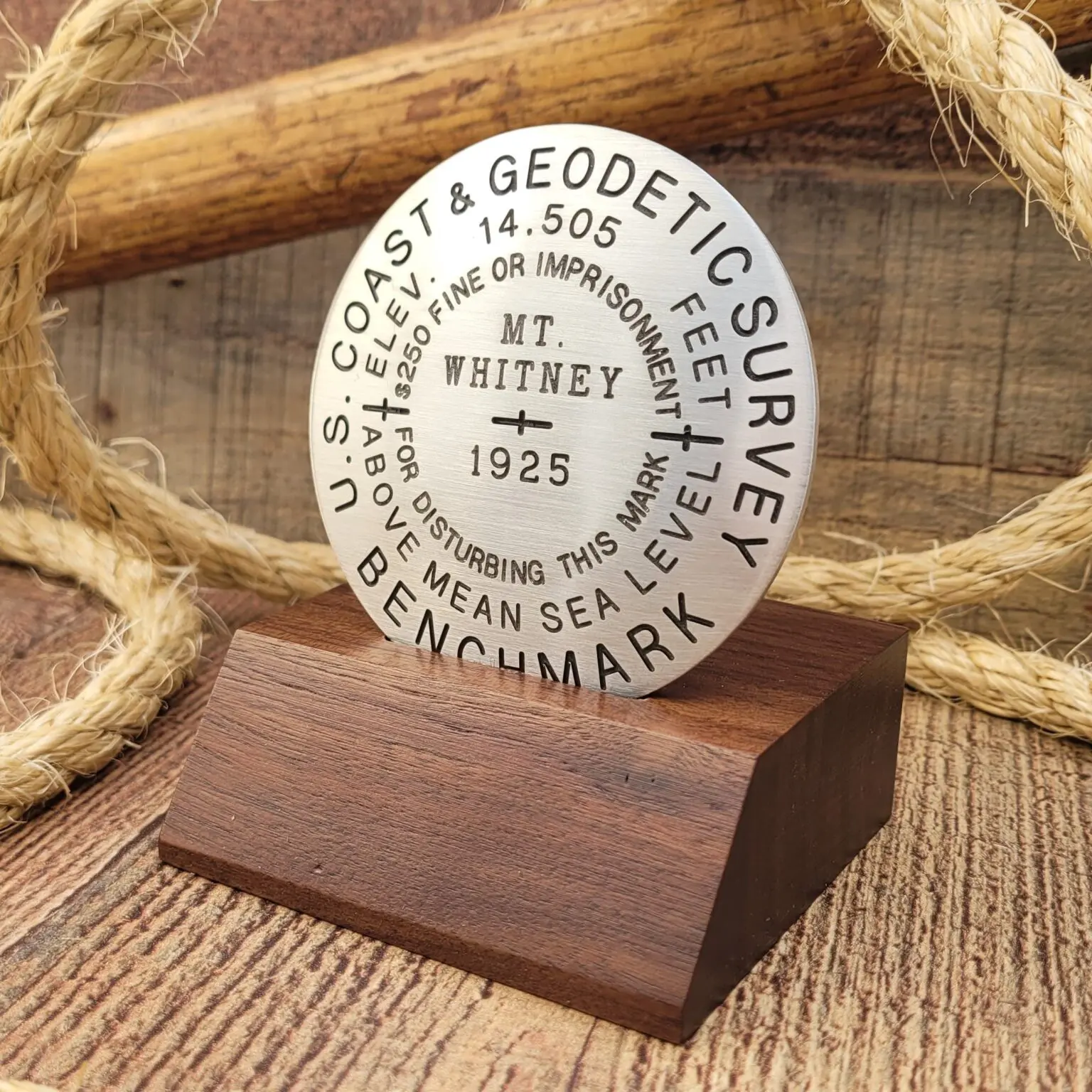 A wooden plaque with rope and a meter