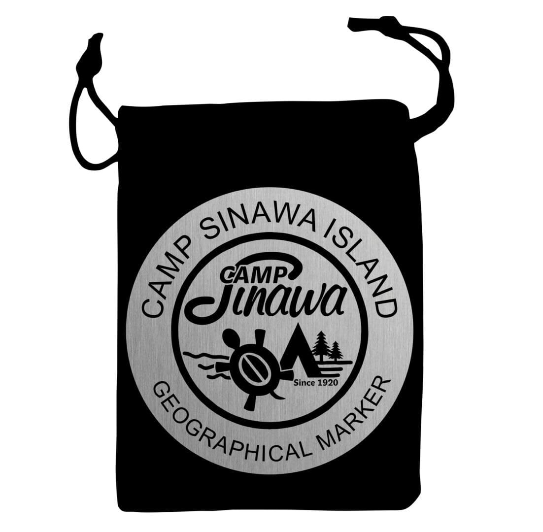 A black bag with a patch of camp sinawa island.
