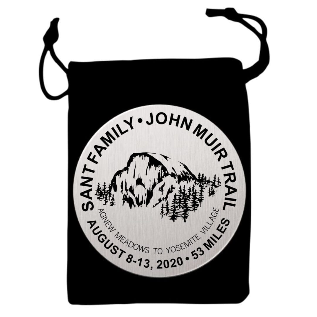 A black bag with a picture of mountains and trees.